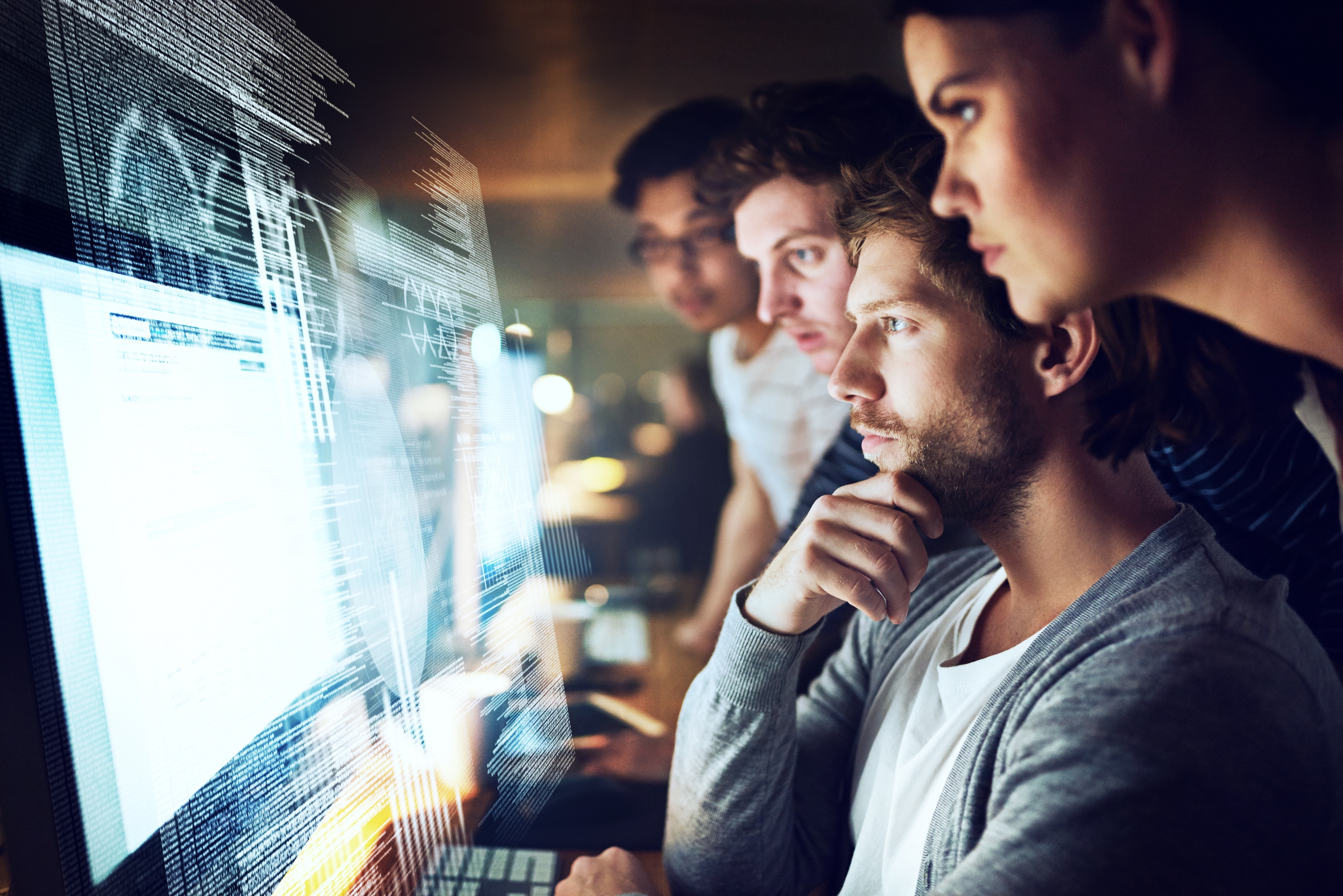 Four people working together in office