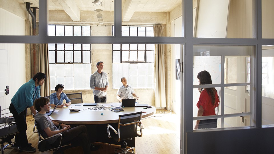 Six people in a loft office