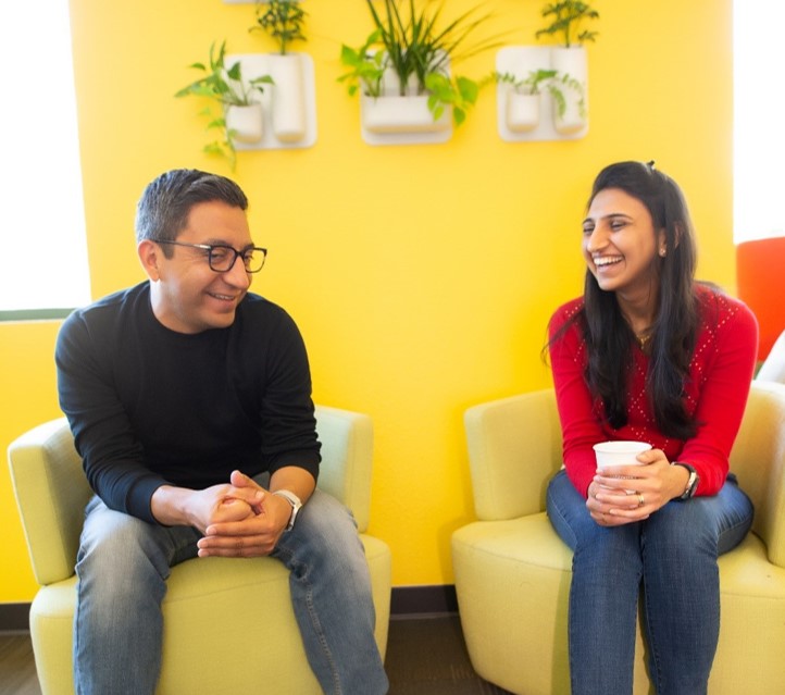 two people sitting on chair and talking