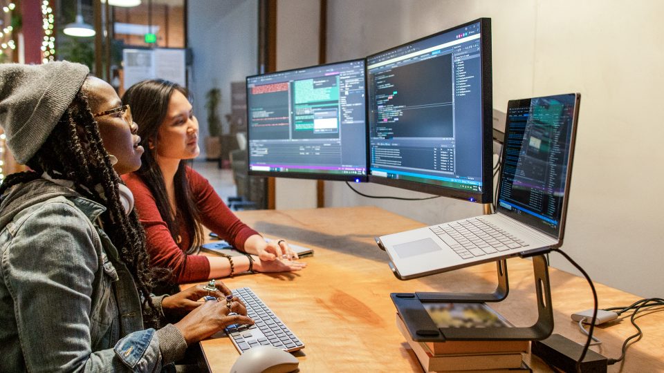 When to Use Machine Learning: Five questions we ask at Microsoft two women gathered around a computer
