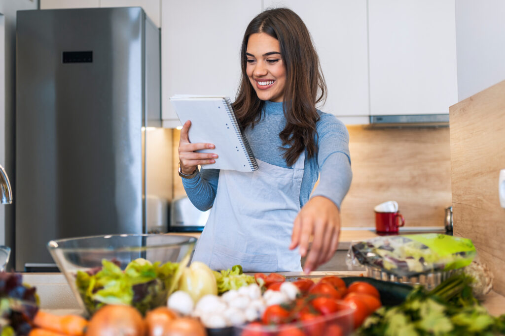 Mom carefully reading a recipe while making a meal.