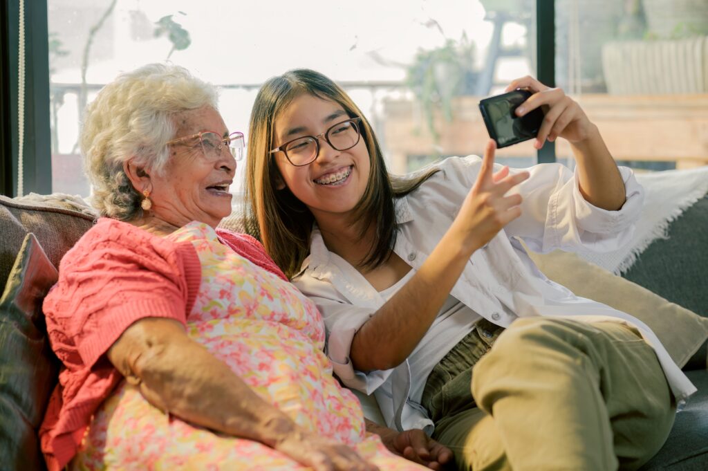 Grandma and granddaughter taking a selfie.