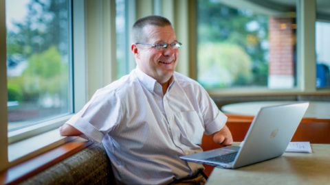John Robinson at a computer