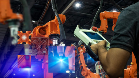 A robotic arm is scene in a factory