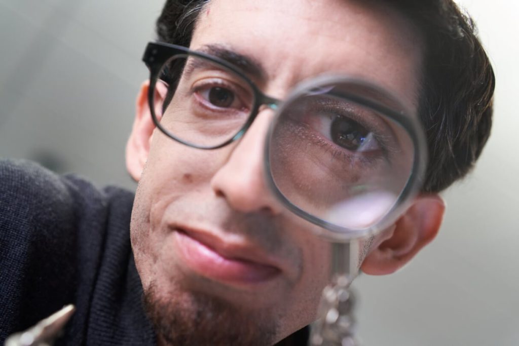 Nicolas Villar, a principal hardware architect for Project Premonition, peers through a magnifying glass