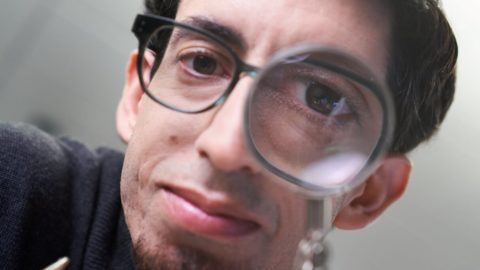 Nicolas Villar, a principal hardware architect for Project Premonition, peers through a magnifying glass