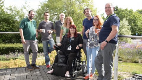 A group of students and staff, experts at the OU’s Institute of Educational Technology standing outside and smiling.