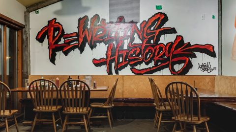 Restaurant wall with graphic reading Rewriting History