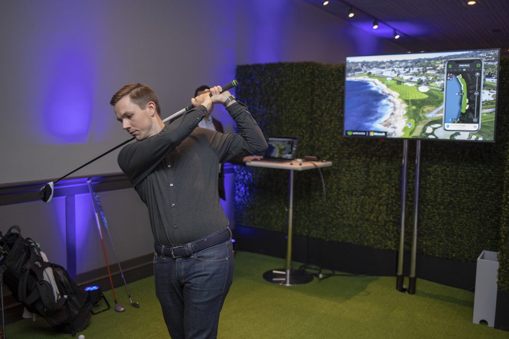 Coleman McDowell follows through on his swing as he demonstrates Arccos Caddie.