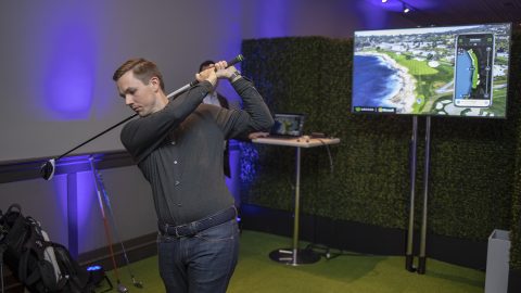 Coleman McDowell follows through on his swing as he demonstrates Arccos Caddie.