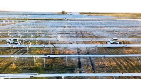 Autonomous vehicles follow workers in a solar farm