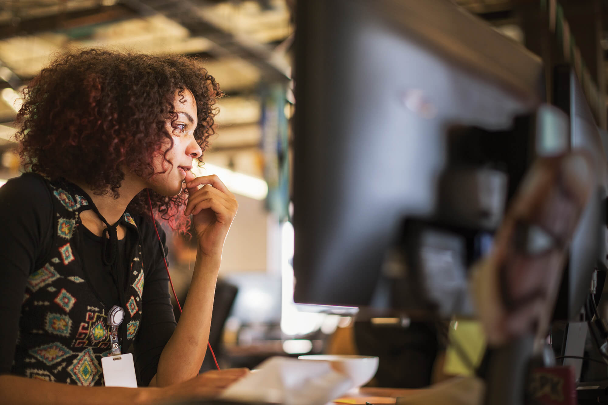 Woman sitting at desk looking at computer screen