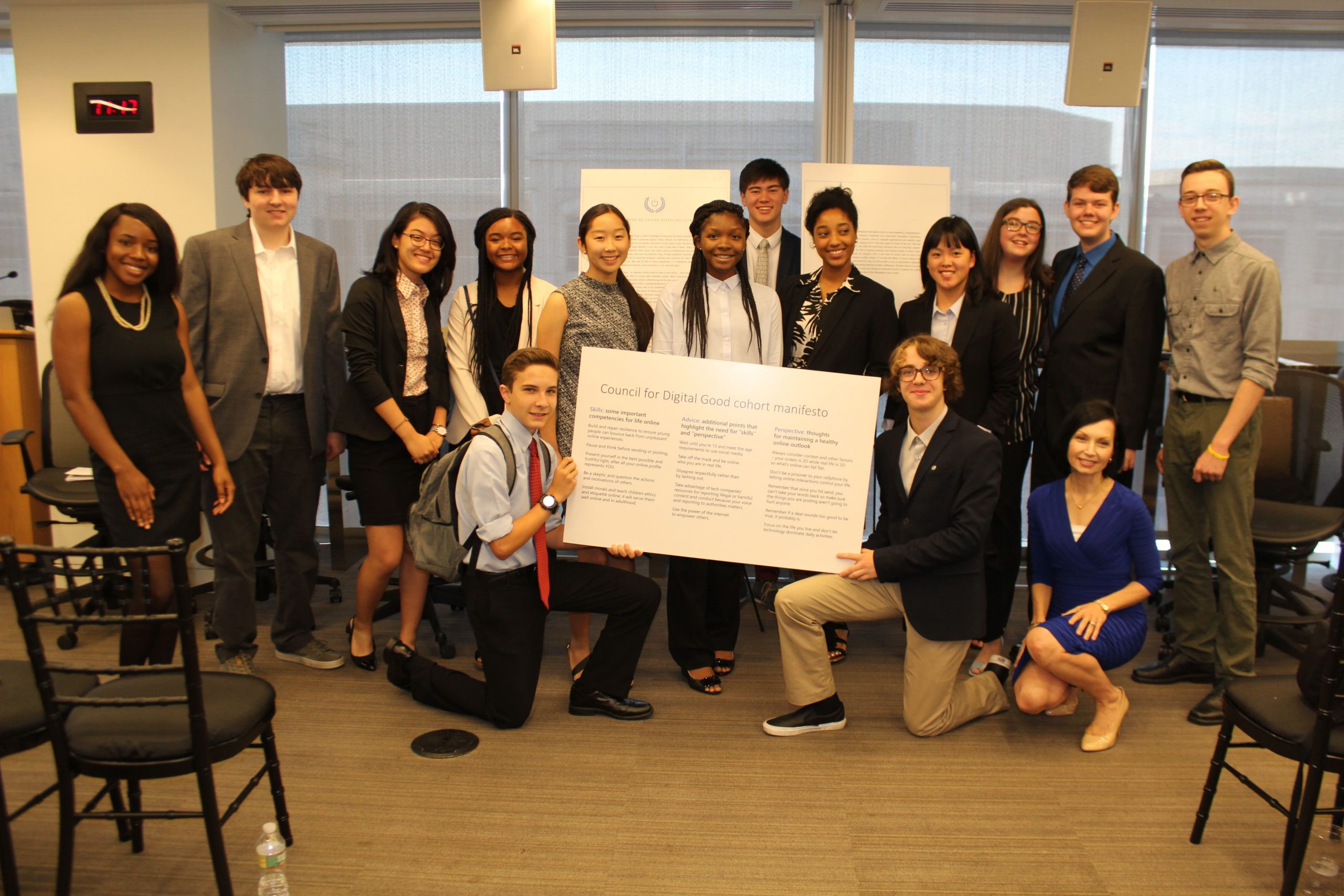 Jacqueline Beauchere, kneeling, lower right, and Microsoft’s Council for Digital Good with an enlarged copy of the council’s open letter to law- and policymakers, and the cohort’s manifesto for life online in Washington, D.C., on July 19, 2018.