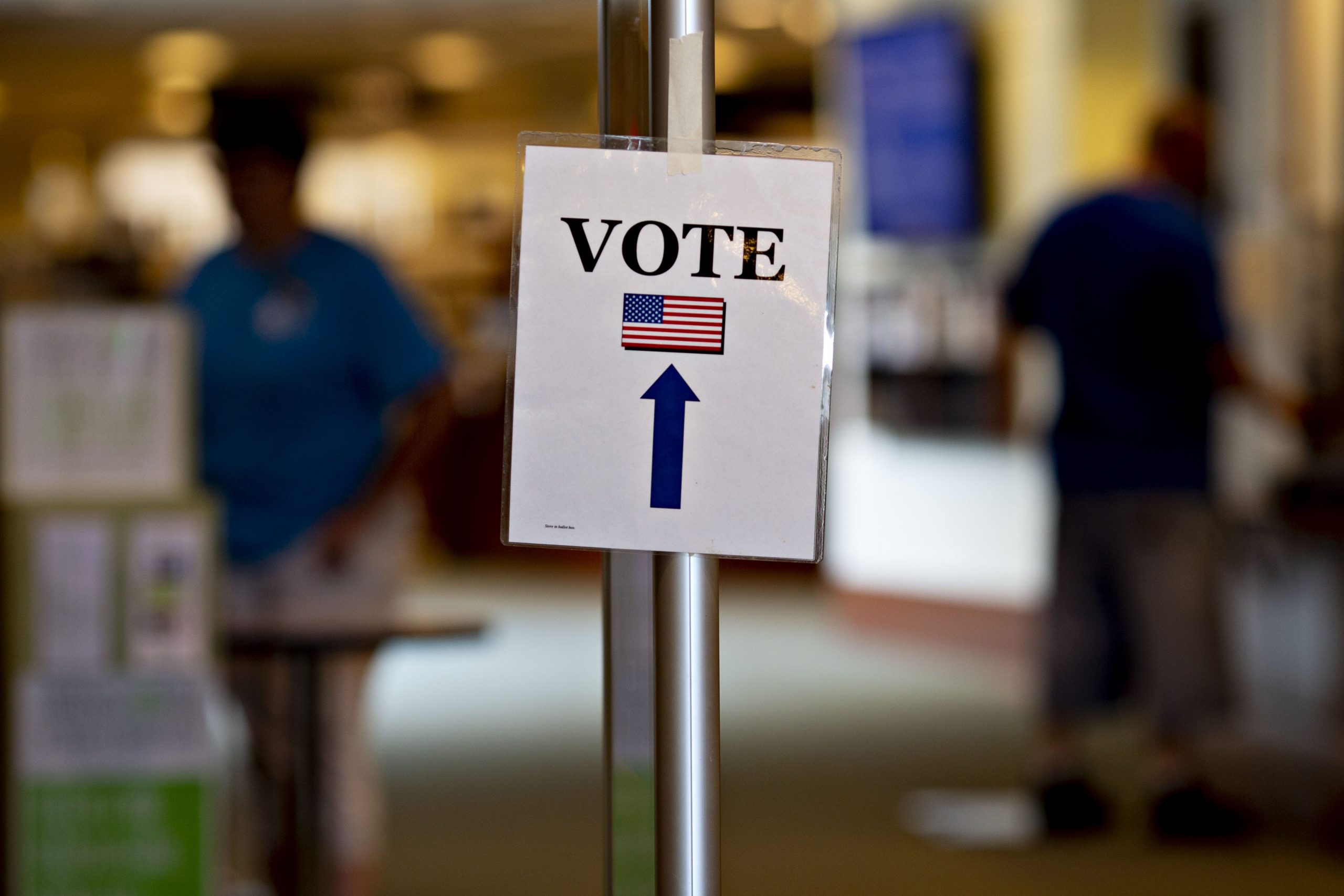 A sign encouraging people to vote hangs on display at a polling station in Wisconsin