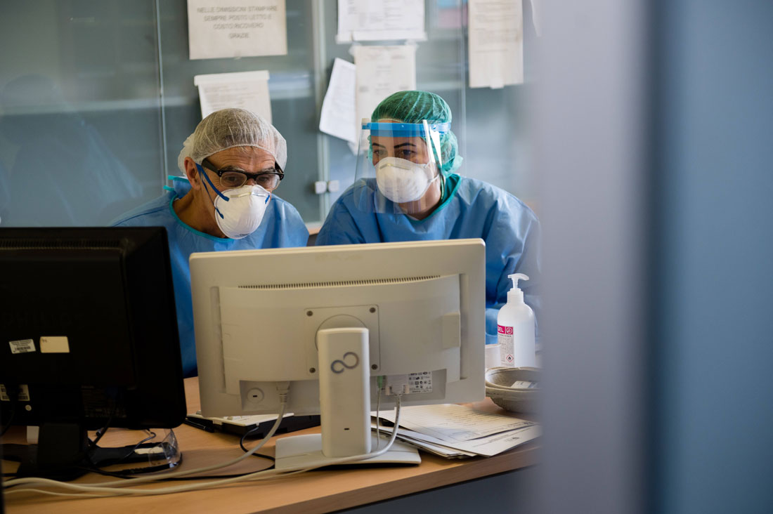 two healthcare workers at a computer