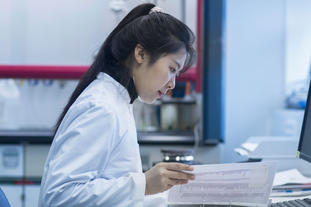 A researcher studies her notes