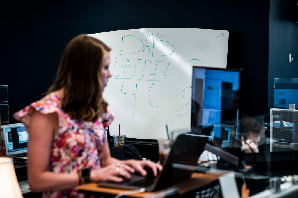 woman looks at computer screen