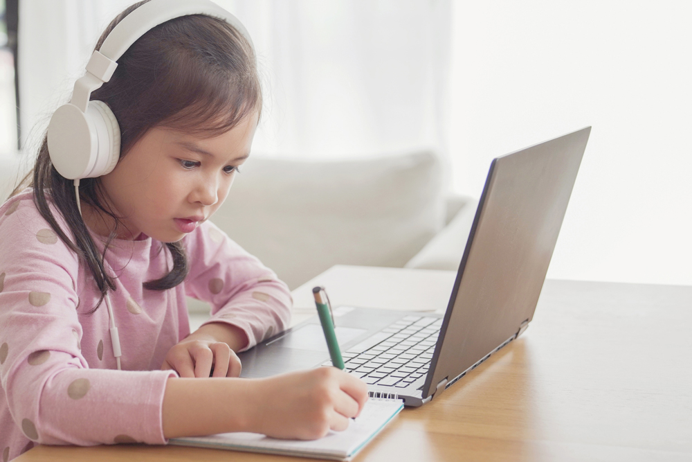 a small girl with a laptop