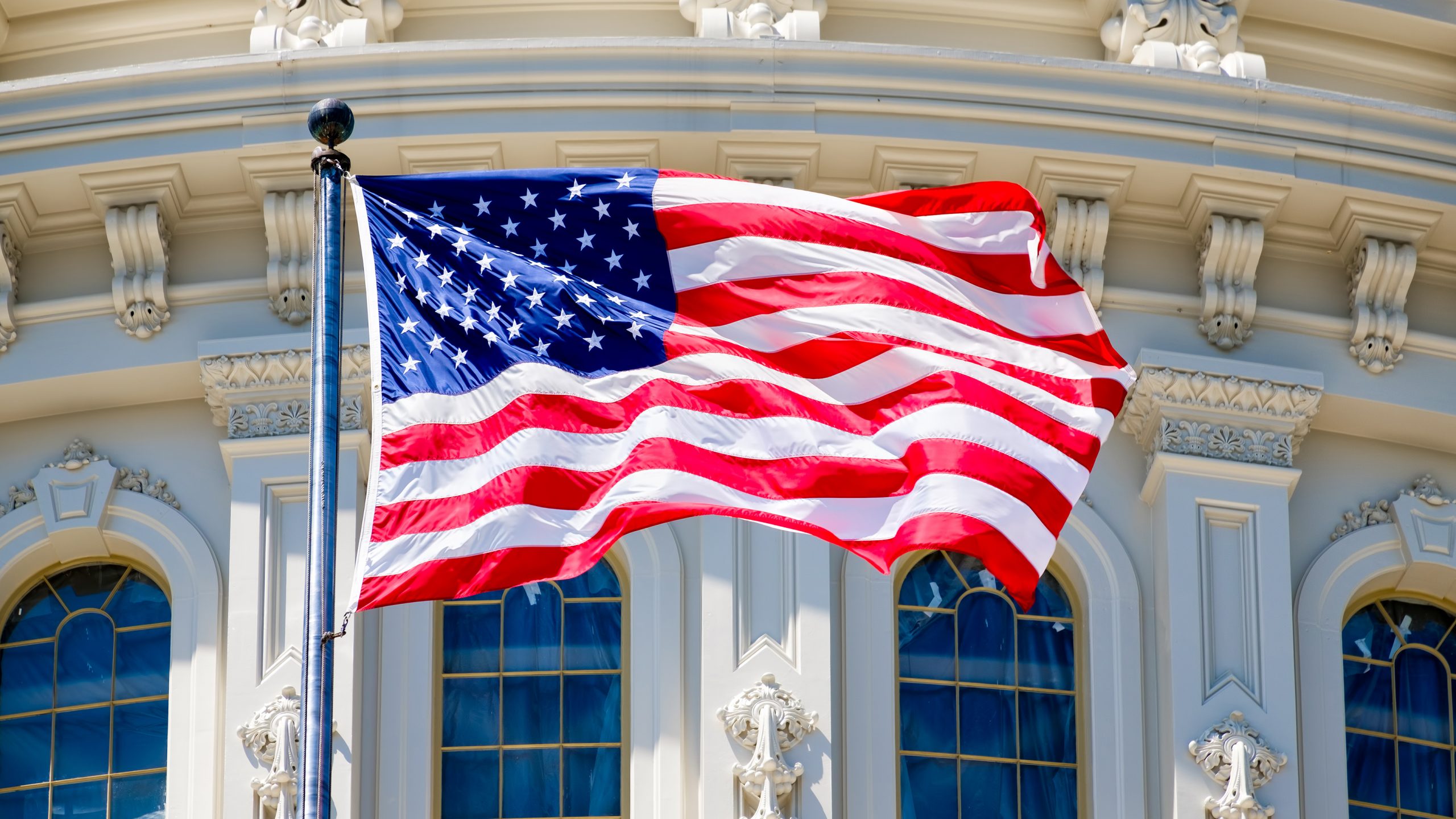 Image of the flag in front of the US Capitol