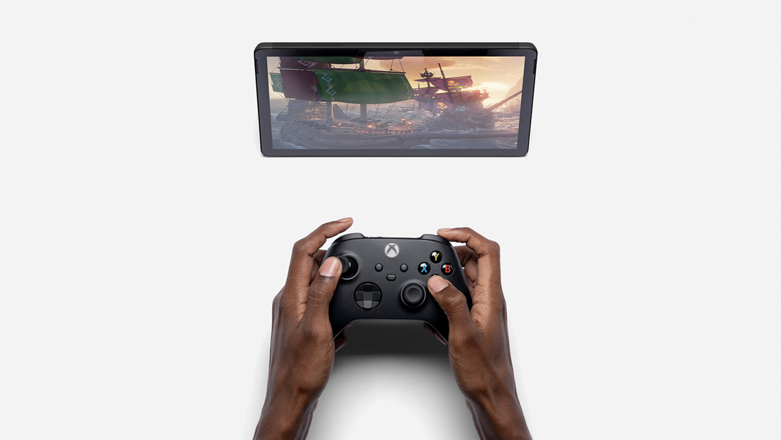 a pair of hands holds an xbox controller
