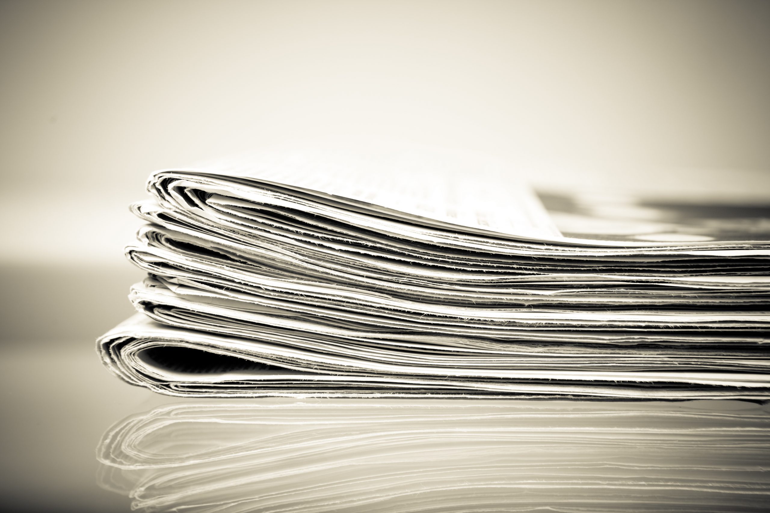 a close up of a stack of newspapers