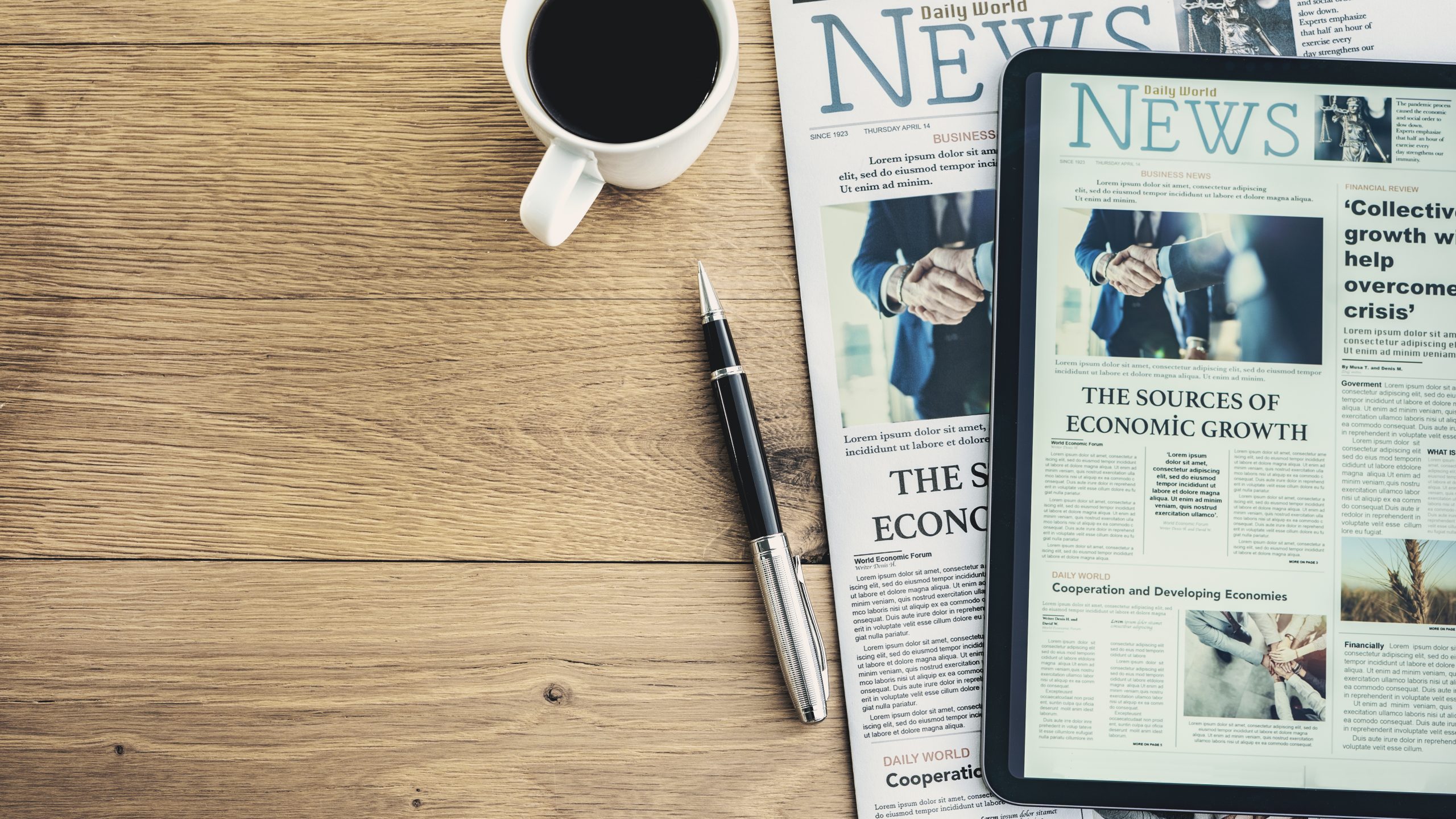 a newspaper and tablet showing the same front page