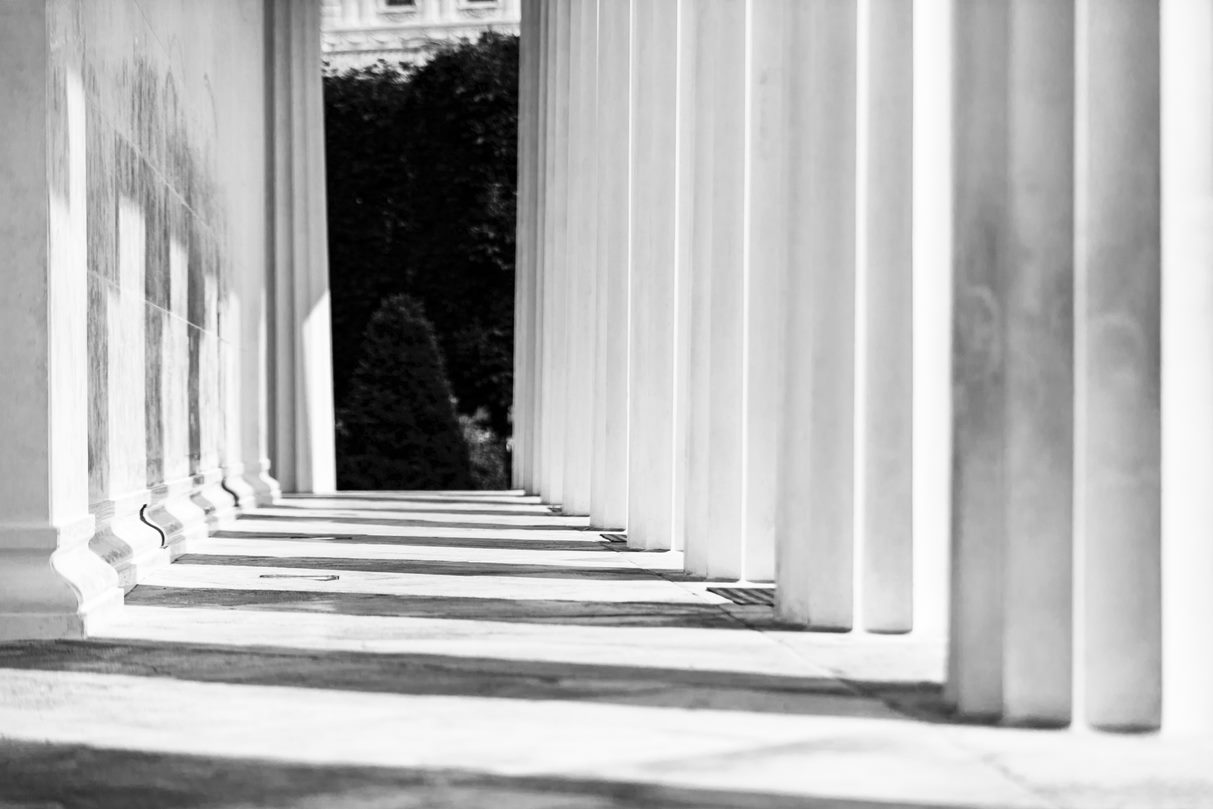 an abstrac view through pillars at a legal establishment
